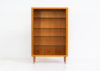 Teak showcase by Svend Dyrlund (Denmark, 1960s). A nice piece with organic shapes and four glass shelves. It has two functional lights on the inside. It is in very good condition.