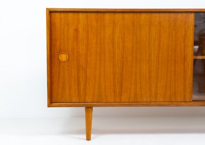 Teak sideboard by Lothar Wegner (Germany, 1960s). It features a teak sliding door, a glass sliding door and a smaller door with a lock and shelves on the inside. A sleek and stylish piece, presented in very good condition.