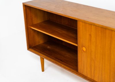 Teak sideboard by Lothar Wegner (Germany, 1960s). It features a teak sliding door, a glass sliding door and a smaller door with a lock and shelves on the inside. A sleek and stylish piece, presented in very good condition.