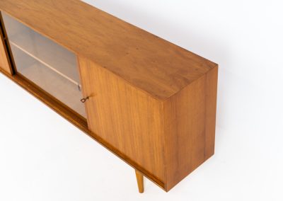 Teak sideboard by Lothar Wegner (Germany, 1960s). It features a teak sliding door, a glass sliding door and a smaller door with a lock and shelves on the inside. A sleek and stylish piece, presented in very good condition.