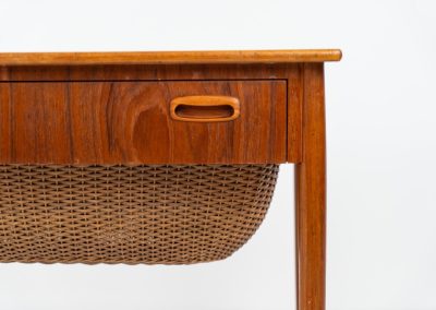 Teak sewing box side table on castors (Denmark, 1960s). This little beauty features a drawer and a wicker basket that can be slid out from both sides. It’s in good condition with some small repair marks.