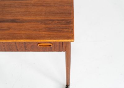 Teak sewing box side table on castors (Denmark, 1960s). This little beauty features a drawer and a wicker basket that can be slid out from both sides. It’s in good condition with some small repair marks.