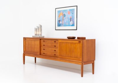 Exceptional sideboard by Henry W. Klein for Bramin (Denmark, 1960s). This is truly a masterpiece! Crafted with high-quality materials and stunning attention to detail, it offers the perfect blend of aesthetics and functionality. This piece features two big sliding doors with adjustable shelves inside, allong with four drawers. The sideboard is in excellent condition!