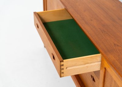 Exceptional sideboard by Henry W. Klein for Bramin (Denmark, 1960s). This is truly a masterpiece! Crafted with high-quality materials and stunning attention to detail, it offers the perfect blend of aesthetics and functionality. This piece features two big sliding doors with adjustable shelves inside, allong with four drawers. The sideboard is in excellent condition!