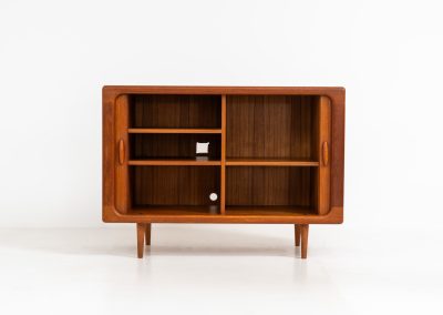 Svend Dyrlund teak sideboard with tambour doors (Denmark, 1960s). A fabulous sideboard that perfectly combines nice organic shapes and loads of detail, like the tambour sliding doors and the beautiful handles. It offers lots of storage space with three adjustable shelves on the inside. A perfect piece to store record player gear. In splendid condition! Labeled by maker.