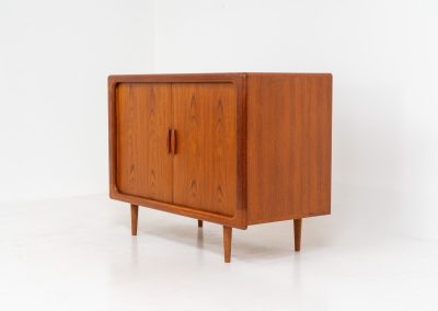 Svend Dyrlund teak sideboard with tambour doors (Denmark, 1960s). A fabulous sideboard that perfectly combines nice organic shapes and loads of detail, like the tambour sliding doors and the beautiful handles. It offers lots of storage space with three adjustable shelves on the inside. A perfect piece to store record player gear. In splendid condition! Labeled by maker.