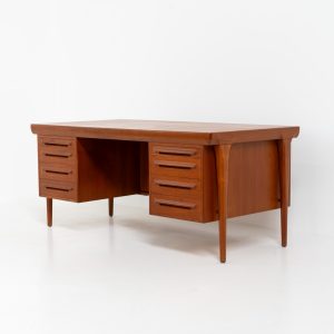 Rare executive writing desk by Ib Kofod Larsen for Faarup (Denmark, 1960s). This huge and absolutely gorgeous piece is one of the highest-quality desks we’ve come across, with an incredible attention to detail! Featuring a spacious desktop with a beautiful woodgrain, two cabinets with locks and an open shelve on the backside, two pull/out leafs and six big drawers on the frontside. Two of the drawers can be securely locked with cleverly hidden locks on the inside. The desk is double sided which makes it a stunning piece to place in the center of a room. This piece presents itself in very good condition. All drawers, doors & locks function very smoothly! It can be easily disassembled for transport or storage.