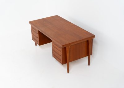 Rare executive writing desk by Ib Kofod Larsen for Faarup (Denmark, 1960s). This huge and absolutely gorgeous piece is one of the highest-quality desks we’ve come across, with an incredible attention to detail! Featuring a spacious desktop with a beautiful woodgrain, two cabinets with locks and an open shelve on the backside, two pull/out leafs and six big drawers on the frontside. Two of the drawers can be securely locked with cleverly hidden locks on the inside. The desk is double sided which makes it a stunning piece to place in the center of a room. This piece presents itself in very good condition. All drawers, doors & locks function very smoothly! It can be easily disassembled for transport or storage.