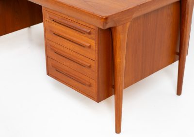 Rare executive writing desk by Ib Kofod Larsen for Faarup (Denmark, 1960s). This huge and absolutely gorgeous piece is one of the highest-quality desks we’ve come across, with an incredible attention to detail! Featuring a spacious desktop with a beautiful woodgrain, two cabinets with locks and an open shelve on the backside, two pull/out leafs and six big drawers on the frontside. Two of the drawers can be securely locked with cleverly hidden locks on the inside. The desk is double sided which makes it a stunning piece to place in the center of a room. This piece presents itself in very good condition. All drawers, doors & locks function very smoothly! It can be easily disassembled for transport or storage.