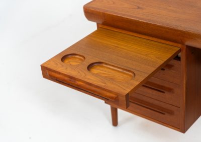 Rare executive writing desk by Ib Kofod Larsen for Faarup (Denmark, 1960s). This huge and absolutely gorgeous piece is one of the highest-quality desks we’ve come across, with an incredible attention to detail! Featuring a spacious desktop with a beautiful woodgrain, two cabinets with locks and an open shelve on the backside, two pull/out leafs and six big drawers on the frontside. Two of the drawers can be securely locked with cleverly hidden locks on the inside. The desk is double sided which makes it a stunning piece to place in the center of a room. This piece presents itself in very good condition. All drawers, doors & locks function very smoothly! It can be easily disassembled for transport or storage.