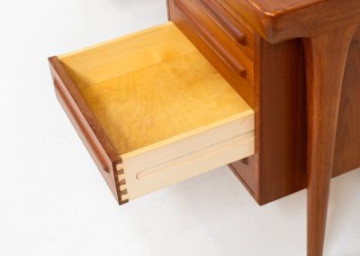 Rare executive writing desk by Ib Kofod Larsen for Faarup (Denmark, 1960s). This huge and absolutely gorgeous piece is one of the highest-quality desks we’ve come across, with an incredible attention to detail! Featuring a spacious desktop with a beautiful woodgrain, two cabinets with locks and an open shelve on the backside, two pull/out leafs and six big drawers on the frontside. Two of the drawers can be securely locked with cleverly hidden locks on the inside. The desk is double sided which makes it a stunning piece to place in the center of a room. This piece presents itself in very good condition. All drawers, doors & locks function very smoothly! It can be easily disassembled for transport or storage.