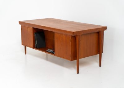 Rare executive writing desk by Ib Kofod Larsen for Faarup (Denmark, 1960s). This huge and absolutely gorgeous piece is one of the highest-quality desks we’ve come across, with an incredible attention to detail! Featuring a spacious desktop with a beautiful woodgrain, two cabinets with locks and an open shelve on the backside, two pull/out leafs and six big drawers on the frontside. Two of the drawers can be securely locked with cleverly hidden locks on the inside. The desk is double sided which makes it a stunning piece to place in the center of a room. This piece presents itself in very good condition. All drawers, doors & locks function very smoothly! It can be easily disassembled for transport or storage.