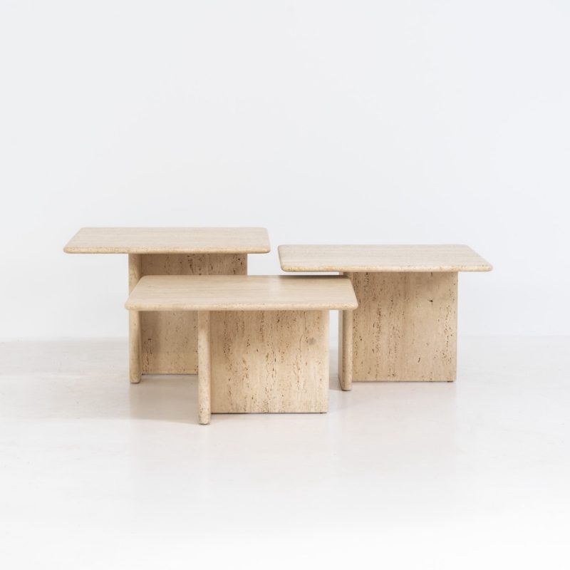 Set of 3 travertine nesting tables (Italy, 1970s). This gorgeous set, crafted in Italy, showcases a beautiful coarse grain that highlights the natural beauty of the stone. This clean and minimalistic design allows for versatile styling, offering endless combinations for various spaces. The tables are in excellent condition, free from cracks, chips or any damage.