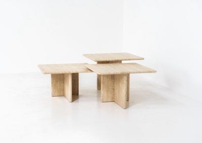 Set of 3 travertine nesting tables (Italy, 1970s). This gorgeous set, crafted in Italy, showcases a beautiful coarse grain that highlights the natural beauty of the stone. This clean and minimalistic design allows for versatile styling, offering endless combinations for various spaces. The tables are in excellent condition, free from cracks, chips or any damage.