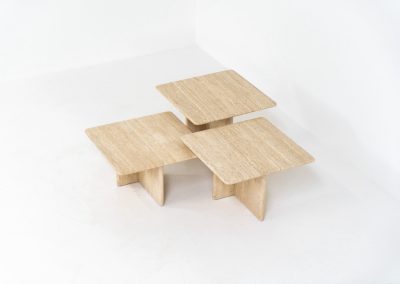 Set of 3 travertine nesting tables (Italy, 1970s). This gorgeous set, crafted in Italy, showcases a beautiful coarse grain that highlights the natural beauty of the stone. This clean and minimalistic design allows for versatile styling, offering endless combinations for various spaces. The tables are in excellent condition, free from cracks, chips or any damage.