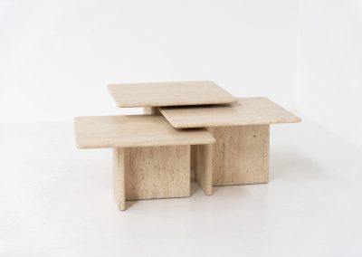 Set of 3 travertine nesting tables (Italy, 1970s). This gorgeous set, crafted in Italy, showcases a beautiful coarse grain that highlights the natural beauty of the stone. This clean and minimalistic design allows for versatile styling, offering endless combinations for various spaces. The tables are in excellent condition, free from cracks, chips or any damage.