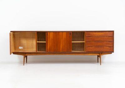 Paola sideboard by Oswald Vermaercke for V-Form (Belgium, 1959). An amazing design with a lot of details and a highly sought after dimensions. Featuring one folding door, two sliding doors and four drawers with beautifully curved bentwood interiors. It’s made out of teak and stands on an oak frame. While it has been restored, it still shows signs of its history, with visible use marks and some veneer patches from repairs. Given its age, it remains in good vintage condition.