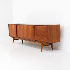 Paola sideboard by Oswald Vermaercke for V-Form (Belgium, 1959). An amazing design with a lot of details and a highly sought after dimensions. Featuring one folding door, two sliding doors and four drawers with beautifully curved bentwood interiors. It’s made out of teak and stands on an oak frame. While it has been restored, it still shows signs of its history, with visible use marks and some veneer patches from repairs. Given its age, it remains in good vintage condition.