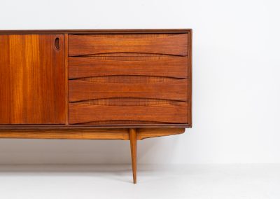 Paola sideboard by Oswald Vermaercke for V-Form (Belgium, 1959). An amazing design with a lot of details and a highly sought after dimensions. Featuring one folding door, two sliding doors and four drawers with beautifully curved bentwood interiors. It’s made out of teak and stands on an oak frame. While it has been restored, it still shows signs of its history, with visible use marks and some veneer patches from repairs. Given its age, it remains in good vintage condition.