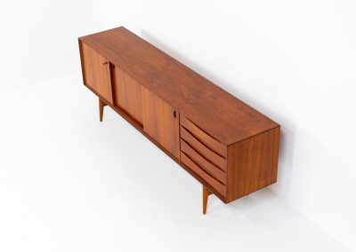Paola sideboard by Oswald Vermaercke for V-Form (Belgium, 1959). An amazing design with a lot of details and a highly sought after dimensions. Featuring one folding door, two sliding doors and four drawers with beautifully curved bentwood interiors. It’s made out of teak and stands on an oak frame. While it has been restored, it still shows signs of its history, with visible use marks and some veneer patches from repairs. Given its age, it remains in good vintage condition.