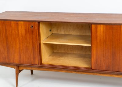 Paola sideboard by Oswald Vermaercke for V-Form (Belgium, 1959). An amazing design with a lot of details and a highly sought after dimensions. Featuring one folding door, two sliding doors and four drawers with beautifully curved bentwood interiors. It’s made out of teak and stands on an oak frame. While it has been restored, it still shows signs of its history, with visible use marks and some veneer patches from repairs. Given its age, it remains in good vintage condition.