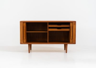 Svend Dyrlund teak sideboard with tambour doors (Denmark, 1960s). A wonderful sideboard with sought after dimensions. It perfectly combines very organic shapes and loads of detail, like the tambour sliding doors and the beautiful handles. It offers lots of storage space with an adjustable shelve and two drawers on the inside. An ideal piece for storing a record player and vinyls. Except for a little color difference on the top, this piece is in mint condition.