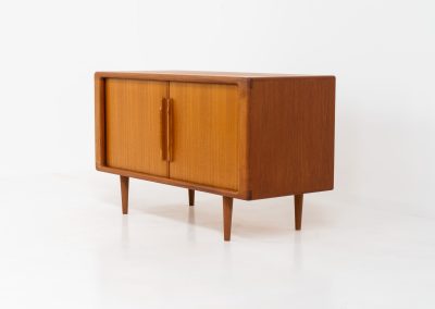 Svend Dyrlund teak sideboard with tambour doors (Denmark, 1960s). A wonderful sideboard with sought after dimensions. It perfectly combines very organic shapes and loads of detail, like the tambour sliding doors and the beautiful handles. It offers lots of storage space with an adjustable shelve and two drawers on the inside. An ideal piece for storing a record player and vinyls. Except for a little color difference on the top, this piece is in mint condition.
