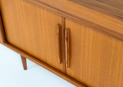 Svend Dyrlund teak sideboard with tambour doors (Denmark, 1960s). A wonderful sideboard with sought after dimensions. It perfectly combines very organic shapes and loads of detail, like the tambour sliding doors and the beautiful handles. It offers lots of storage space with an adjustable shelve and two drawers on the inside. An ideal piece for storing a record player and vinyls. Except for a little color difference on the top, this piece is in mint condition.