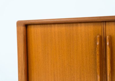 Svend Dyrlund teak sideboard with tambour doors (Denmark, 1960s). A wonderful sideboard with sought after dimensions. It perfectly combines very organic shapes and loads of detail, like the tambour sliding doors and the beautiful handles. It offers lots of storage space with an adjustable shelve and two drawers on the inside. An ideal piece for storing a record player and vinyls. Except for a little color difference on the top, this piece is in mint condition.