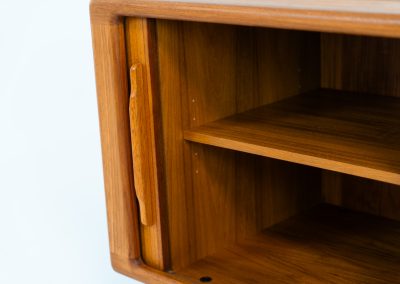 Svend Dyrlund teak sideboard with tambour doors (Denmark, 1960s). A wonderful sideboard with sought after dimensions. It perfectly combines very organic shapes and loads of detail, like the tambour sliding doors and the beautiful handles. It offers lots of storage space with an adjustable shelve and two drawers on the inside. An ideal piece for storing a record player and vinyls. Except for a little color difference on the top, this piece is in mint condition.