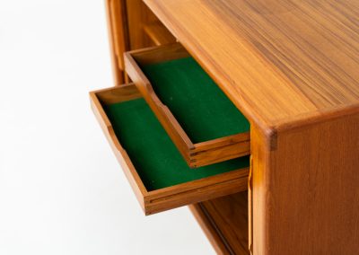 Svend Dyrlund teak sideboard with tambour doors (Denmark, 1960s). A wonderful sideboard with sought after dimensions. It perfectly combines very organic shapes and loads of detail, like the tambour sliding doors and the beautiful handles. It offers lots of storage space with an adjustable shelve and two drawers on the inside. An ideal piece for storing a record player and vinyls. Except for a little color difference on the top, this piece is in mint condition.