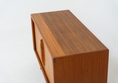 Svend Dyrlund teak sideboard with tambour doors (Denmark, 1960s). A wonderful sideboard with sought after dimensions. It perfectly combines very organic shapes and loads of detail, like the tambour sliding doors and the beautiful handles. It offers lots of storage space with an adjustable shelve and two drawers on the inside. An ideal piece for storing a record player and vinyls. Except for a little color difference on the top, this piece is in mint condition.