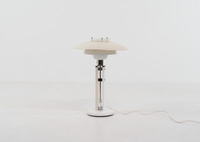 Danish table lamp, 1970s. We don’t know who made this one, but it is clearly inspired by Louis Poulsen’s work. The lamp is easy adjustable in highly with a chrome wheel. It’s made out of white lacquered metal with chrome details. It is in good vintage condition. The shade is not perfectly aligned anymore and the lacquer has some small color differences.
