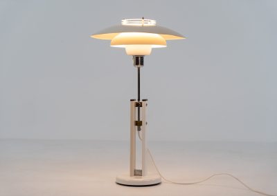 Danish table lamp, 1970s. We don’t know who made this one, but it is clearly inspired by Louis Poulsen’s work. The lamp is easy adjustable in highly with a chrome wheel. It’s made out of white lacquered metal with chrome details. It is in good vintage condition. The shade is not perfectly aligned anymore and the lacquer has some small color differences.
