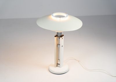 Danish table lamp, 1970s. We don’t know who made this one, but it is clearly inspired by Louis Poulsen’s work. The lamp is easy adjustable in highly with a chrome wheel. It’s made out of white lacquered metal with chrome details. It is in good vintage condition. The shade is not perfectly aligned anymore and the lacquer has some small color differences.