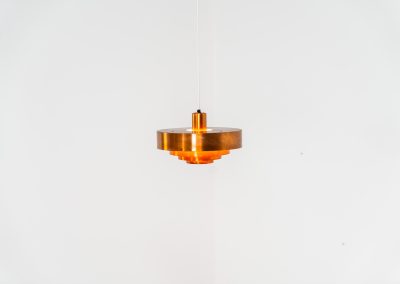 Copper “Roulette” pendant light by Jo Hammerborg for Fog & Mørup (Denmark, 1960s). In our opinion, this is one of Hammerborg’s most stunning designs and increasingly hard to find. Made from solid copper rings with orange detailing on the interior, this lamp is a striking piece, both on and off. It’s in excellent condition, showcasing a beautiful patina on the copper.