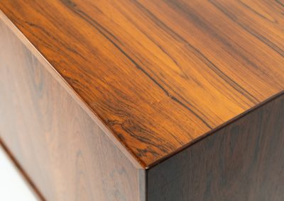 Rare XL sideboard in rosewood by Ib Kofod-Larsen for Faarup (Denmark, 1950s). This piece exudes pure luxury, featuring four large sliding doors with amazing inset handles and lots of storage space with adjustable drawers and shelves inside. The exterior is crafted from rosewood with a glossy finish, showcasing a stunning woodgrain, while the oak-finished interior provides a beautiful contrast. This hard to find piece presents itself in amazing vintage condition with minimal sings of a previous life. The doors slide really smooth. Marked by maker.