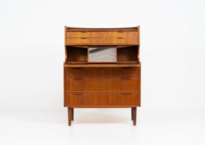 Danish secretary in teak, 1960s. A highly versatile piece featuring seven drawers with beautiful handles, a pull-out leaf, a mirror and lots of storage space. A convenient piece that finds its way in any setting. In very good condition!