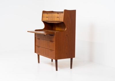 Danish secretary in teak, 1960s. A highly versatile piece featuring seven drawers with beautiful handles, a pull-out leaf, a mirror and lots of storage space. A convenient piece that finds its way in any setting. In very good condition!