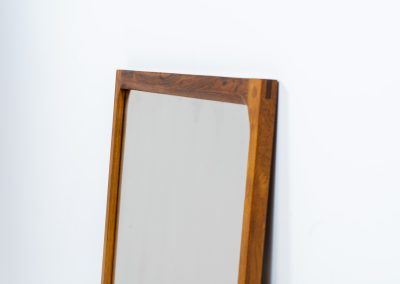 Stunning “No.166” wall mirror in rosewood by Kai Kristiansen for Aksel Kjersgaard (Denmark, 1960s). A beautifully crafted piece made by Denmark’s most renowned mirror makers, Aksel Kjersgaard. The frame, made out of solid Santos rosewood, has a warm and mesmerizing woodgrain and very nice details. In very good condition. Marked by maker.