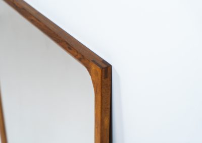Stunning “No.166” wall mirror in rosewood by Kai Kristiansen for Aksel Kjersgaard (Denmark, 1960s). A beautifully crafted piece made by Denmark’s most renowned mirror makers, Aksel Kjersgaard. The frame, made out of solid Santos rosewood, has a warm and mesmerizing woodgrain and very nice details. In very good condition. Marked by maker.