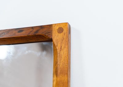 Stunning “No.166” wall mirror in rosewood by Kai Kristiansen for Aksel Kjersgaard (Denmark, 1960s). A beautifully crafted piece made by Denmark’s most renowned mirror makers, Aksel Kjersgaard. The frame, made out of solid Santos rosewood, has a warm and mesmerizing woodgrain and very nice details. In very good condition. Marked by maker.