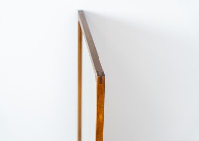 Stunning “No.166” wall mirror in rosewood by Kai Kristiansen for Aksel Kjersgaard (Denmark, 1960s). A beautifully crafted piece made by Denmark’s most renowned mirror makers, Aksel Kjersgaard. The frame, made out of solid Santos rosewood, has a warm and mesmerizing woodgrain and very nice details. In very good condition. Marked by maker.