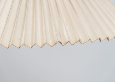 Magnificent Caprani floor lamp by Mads Caprani (Denmark, 1970s). This iconic and hard to find piece features a graceful beech ark, a cast iron base and its original linen pleated shade. The lamp is in original and very good condition, with only minor using traces on the shade, as shown on the pictures. Labeled by maker.