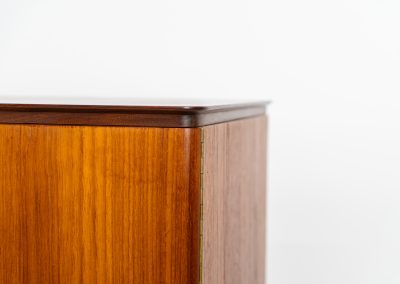 Danish highboard in teak, 1960s. A beautiful mid-century piece crafted in rich teak wood, featuring two spacious doors and two smooth-sliding doors, offering lots of storage and a stylish bar unit inside. The highboard showcases a warm, natural woodgrain, elegant rounded edges, and distinctive handles. It is in very good condition with mild age-related marks.