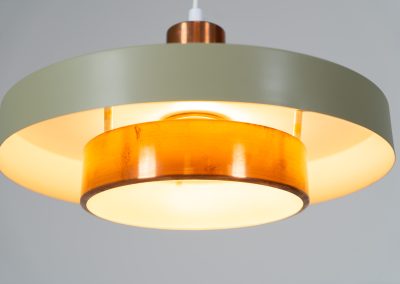 Danish pendant light 1960s. This Danish pendant light from the 1960s features a stunning combination of a copper shade and an olive green lacquered aluminum shade. The copper has a beautiful patina due to its age. The lamp is in very good condition, with a small scuff on the lacquer at the top.