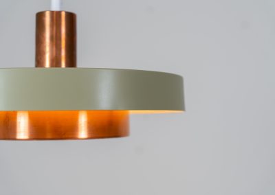 Danish pendant light 1960s. This Danish pendant light from the 1960s features a stunning combination of a copper shade and an olive green lacquered aluminum shade. The copper has a beautiful patina due to its age. The lamp is in very good condition, with a small scuff on the lacquer at the top.