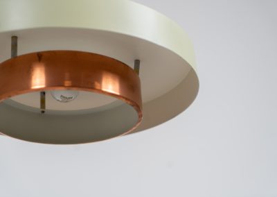 Danish pendant light 1960s. This Danish pendant light from the 1960s features a stunning combination of a copper shade and an olive green lacquered aluminum shade. The copper has a beautiful patina due to its age. The lamp is in very good condition, with a small scuff on the lacquer at the top.