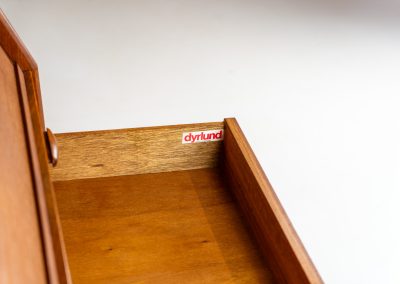 Magnificent secretary by Bent Møller Jørgensen for Svend Dyrlund (Denmark, 1960s). This is an example of high quality Danish craftsmanship. It features stunning aesthetics and nifty details like the tambour door that opens automatically if you pull the upper drawer or the beautiful Dyrlund signature handles. It is in splendid condition and marked by the maker.