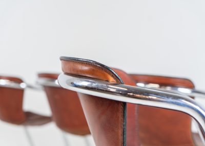 Set of 4 rare leather dining chairs by Willy Rizzo for Metaform (the Netherlands, 1970s). Designed in Italy and manufactured in the Netherlands, these hard to find chairs are a testament to Willy Rizzo’s iconic style. They feature chrome tubular frames and cognac leather seats. The leather showcases a rich patina with visible signs of use, adding character and charm to these remarkable pieces.